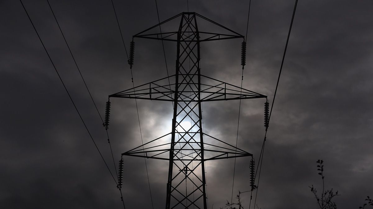 WINSCOMBE, UNITED KINGDOM - NOVEMBER 06:The sun goes behind an electricity pylon that is sited besides the M5 motorway near Winscombe on November 6, 2012 in Somerset, England. The National Gr