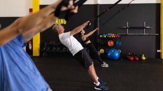 Row of people doing the TRX row exercise