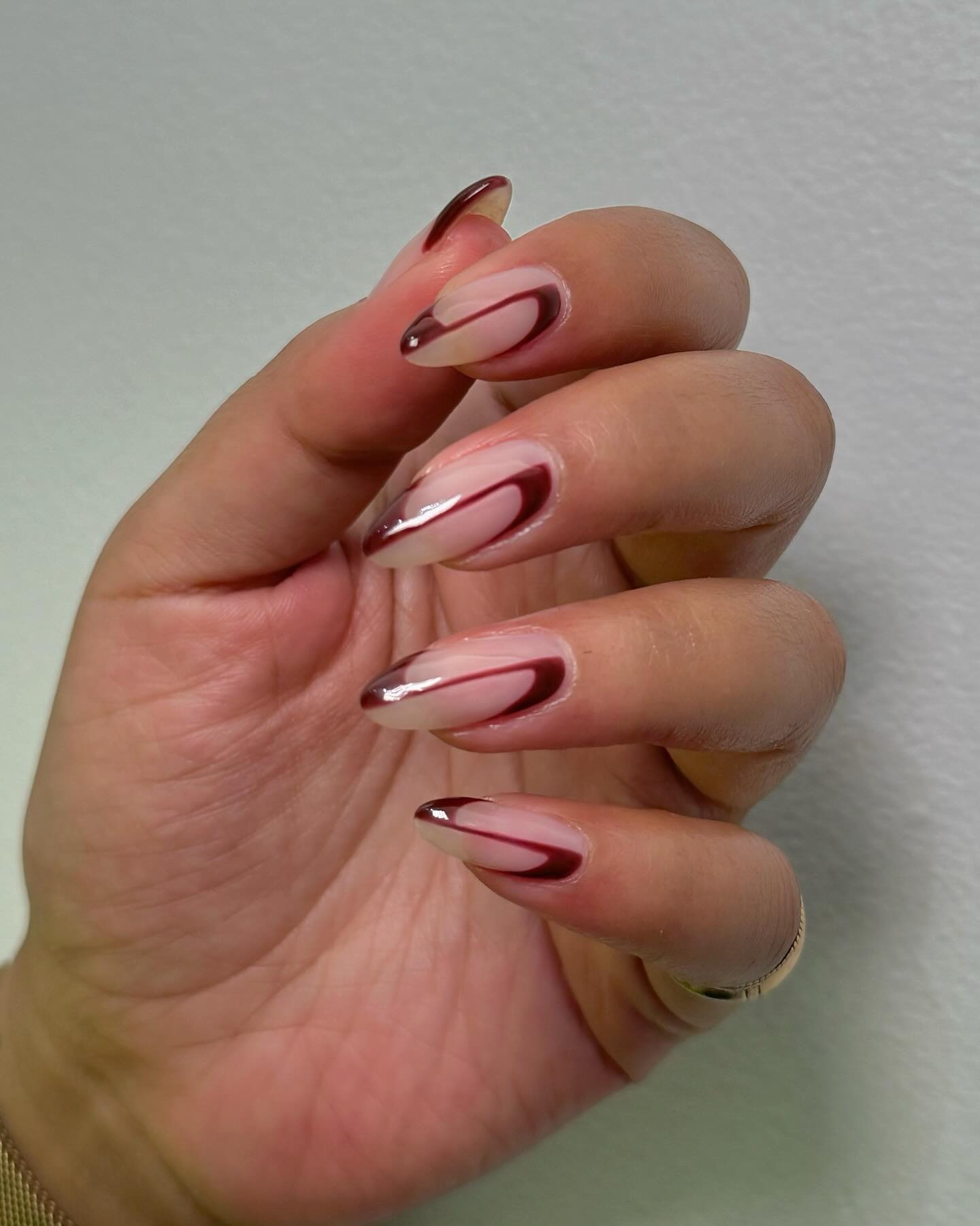 Burgundy negative space nail design