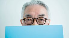 Man hiding his face with blue file
