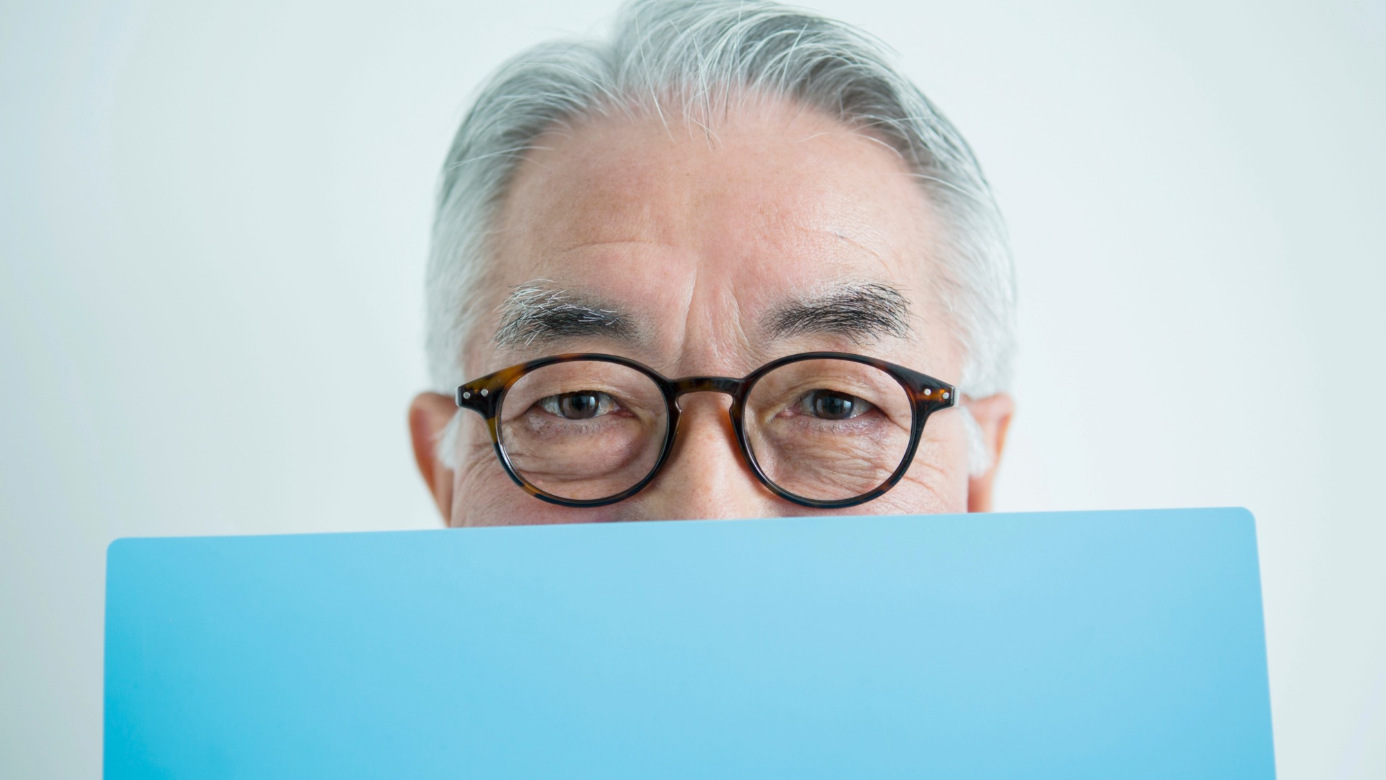 Man hiding his face with blue file
