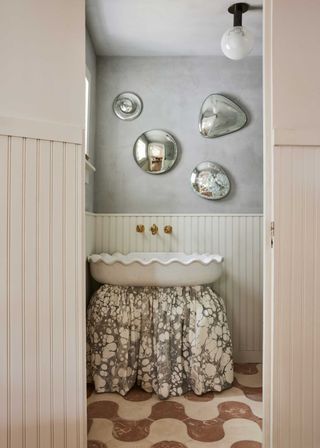 a powder room with a marble sink skirt