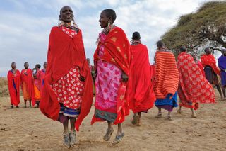 A group of Maasai women shows a traditional Jump dance in a village near Maasai Mara Reserve.