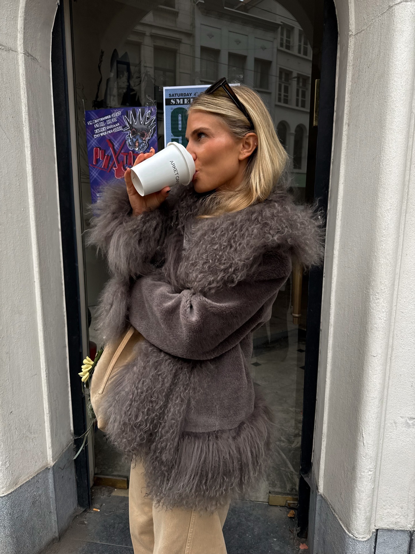 Fashion person Olivia tps wears a faux fur trend 2025. She wears a shearling lined coat.
