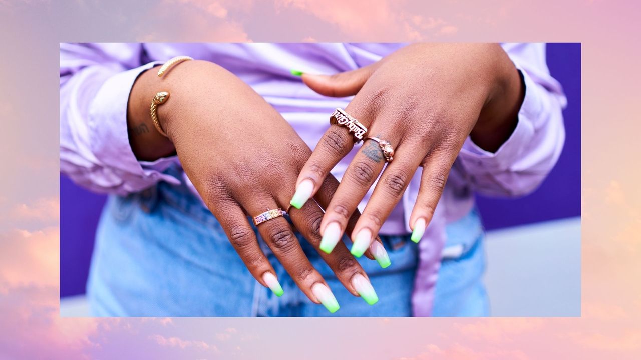 Close up of woman&#039;s hands with lots of gold rings and painted nails - stock photo