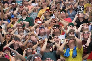 People watch the total solar eclipse of Aug. 21, 2017 in Saluki Stadium on the campus of Southern Illinois University in Carbondale, Illinois