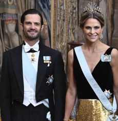 Prince Carl Philip and Princess Madeleine in a suit and black and gown gown at a Nobel dinner