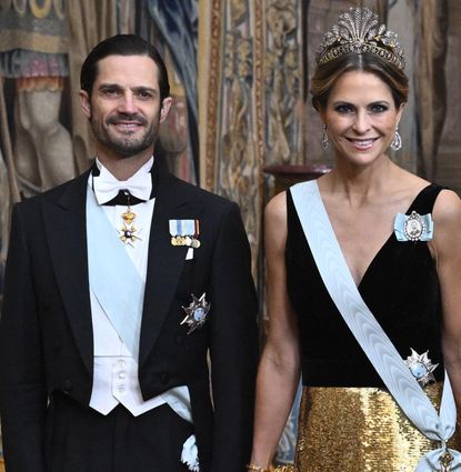 Prince Carl Philip and Princess Madeleine in a suit and black and gown gown at a Nobel dinner