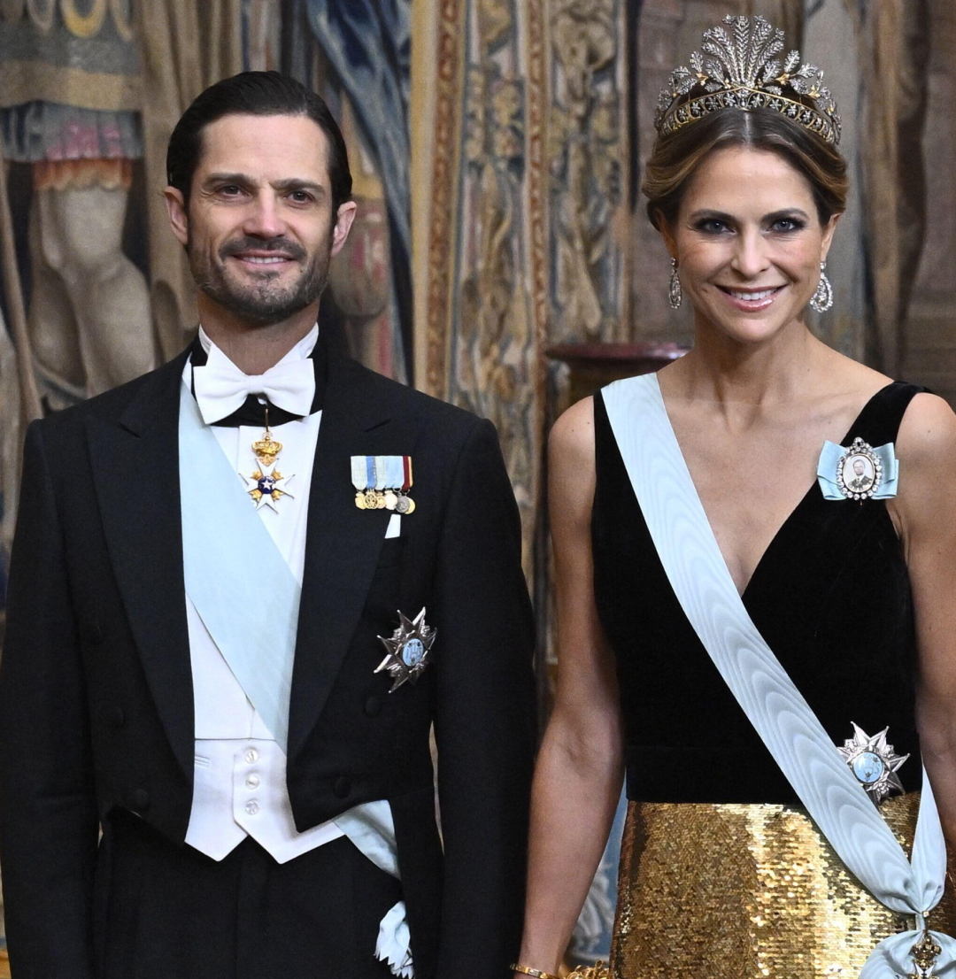 Prince Carl Philip and Princess Madeleine in a suit and black and gown gown at a Nobel dinner