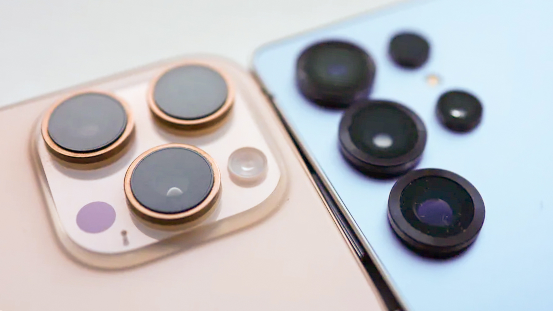 Apple iPhone 16 Pro cameras next to Samsung Galaxy S25 Ultra cameras, close up from back