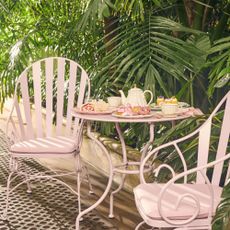 Pink metal bistro set in garden