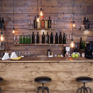 Wooden home bar with bar stools