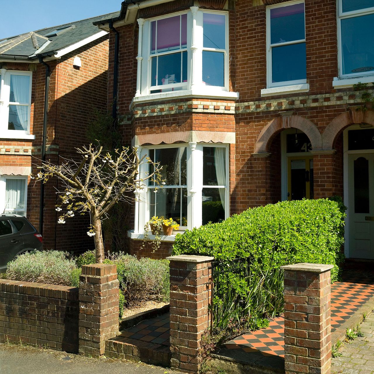 front garden with glass window and brick wall