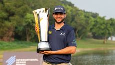 John Catlin poses with the 2024 International Series Macau trophy