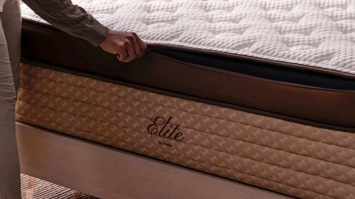 A person unzips the cover on the Helix Midnight Elite Mattress