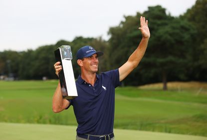 Horschel waves to the crowd while holding the BMW PGA Championship
