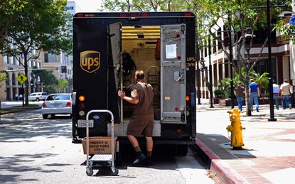 UPS driver unloads a truck.