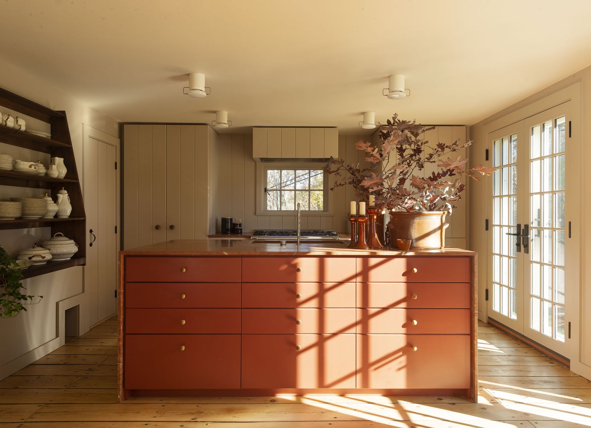 kitchen with terracotta island and open shelving