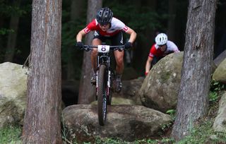 IZU JAPAN JULY 27 Sina Frei of Team Switzerland jumps off a boulder during the Womens Crosscountry race on day four of the Tokyo 2020 Olympic Games at Izu Mountain Bike Course on July 27 2021 in Izu Shizuoka Japan Photo by Michael SteeleGetty Images