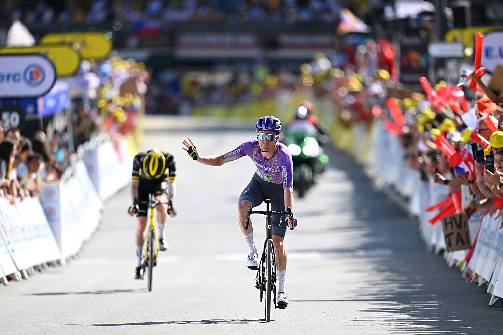Mauro Schmid of Jayco AlUla crosses the finish line in second ahead of Matteo Jorgenson of Visma-Lease a Bike, who takes third