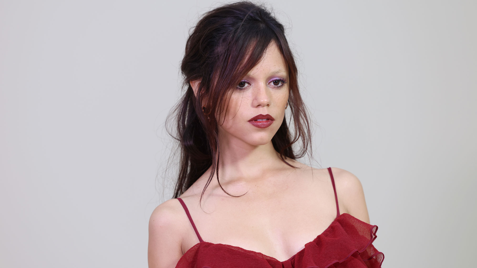 Jenna Ortega wears a red dress at Paris Fashion Week