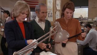 Cagney and Lacey sorting through clothing at the police station.