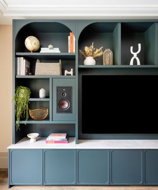 blue built-in media wlal tv cabinet with decorative accessories