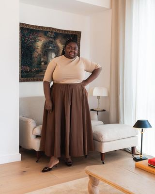 @abimarvel wearing a brown maxi skirt and top with mules