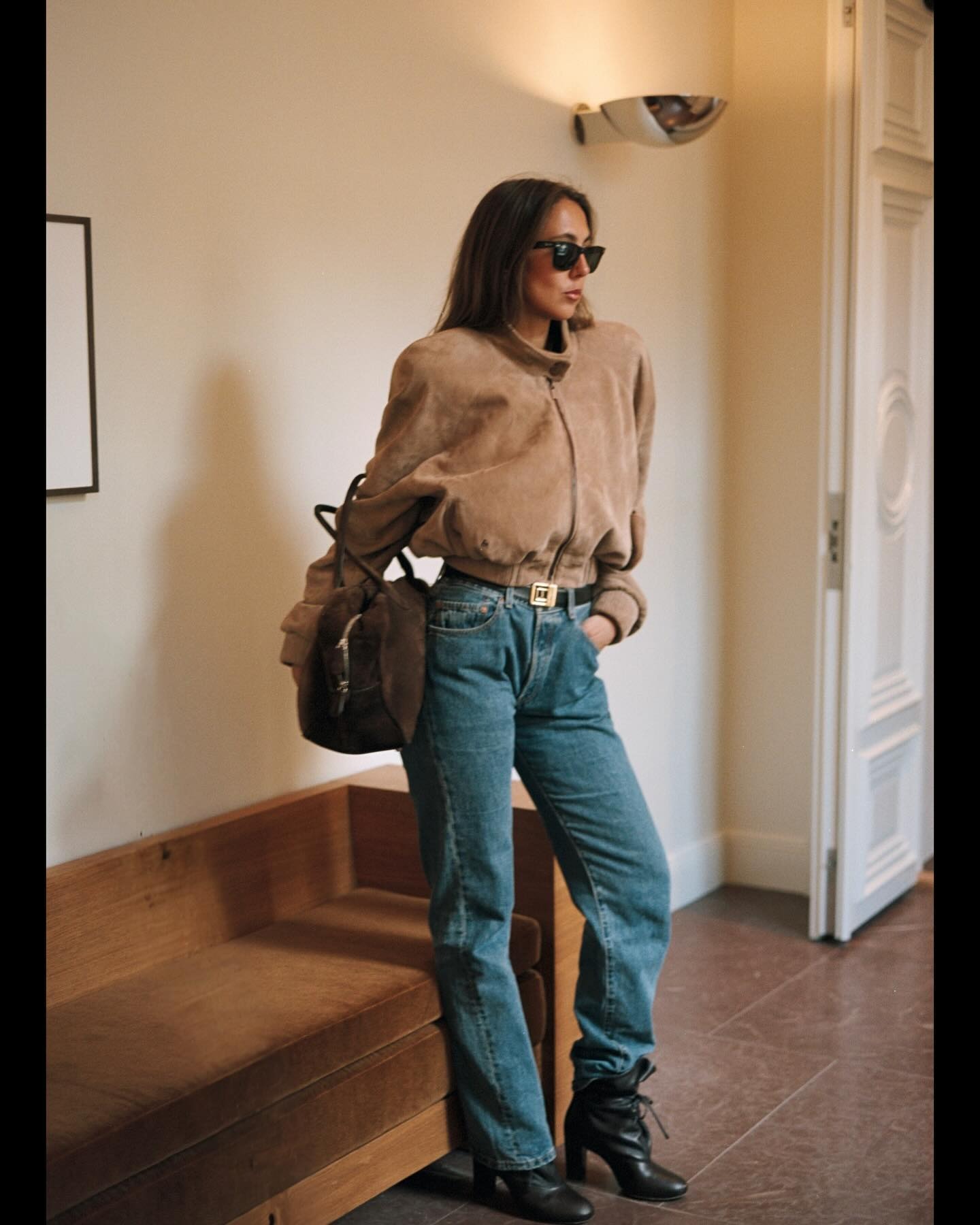 Hanna Marzouki Widlund wearing jeans with a suede bomber jacket and boots.