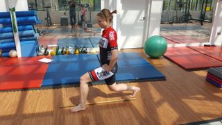 Female cyclist doing lunges to avoid knee pain while cycling