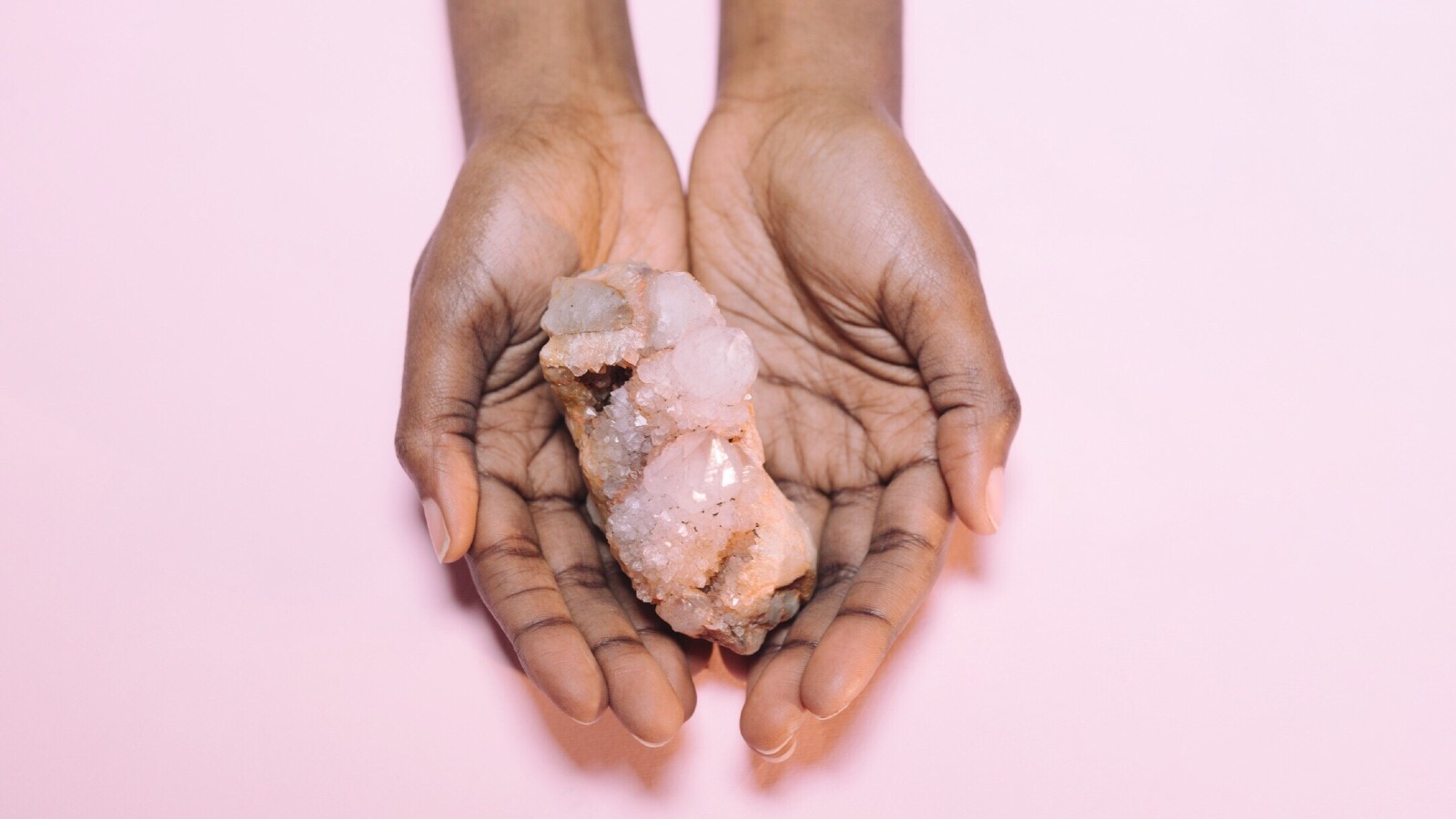 Close-up of hand holding crystal - stock photo