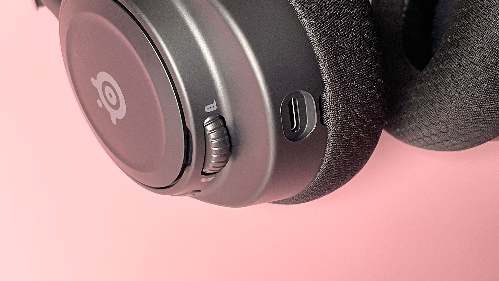 The SteelSeries Arctis Nova 7 Wireless on a pink background.