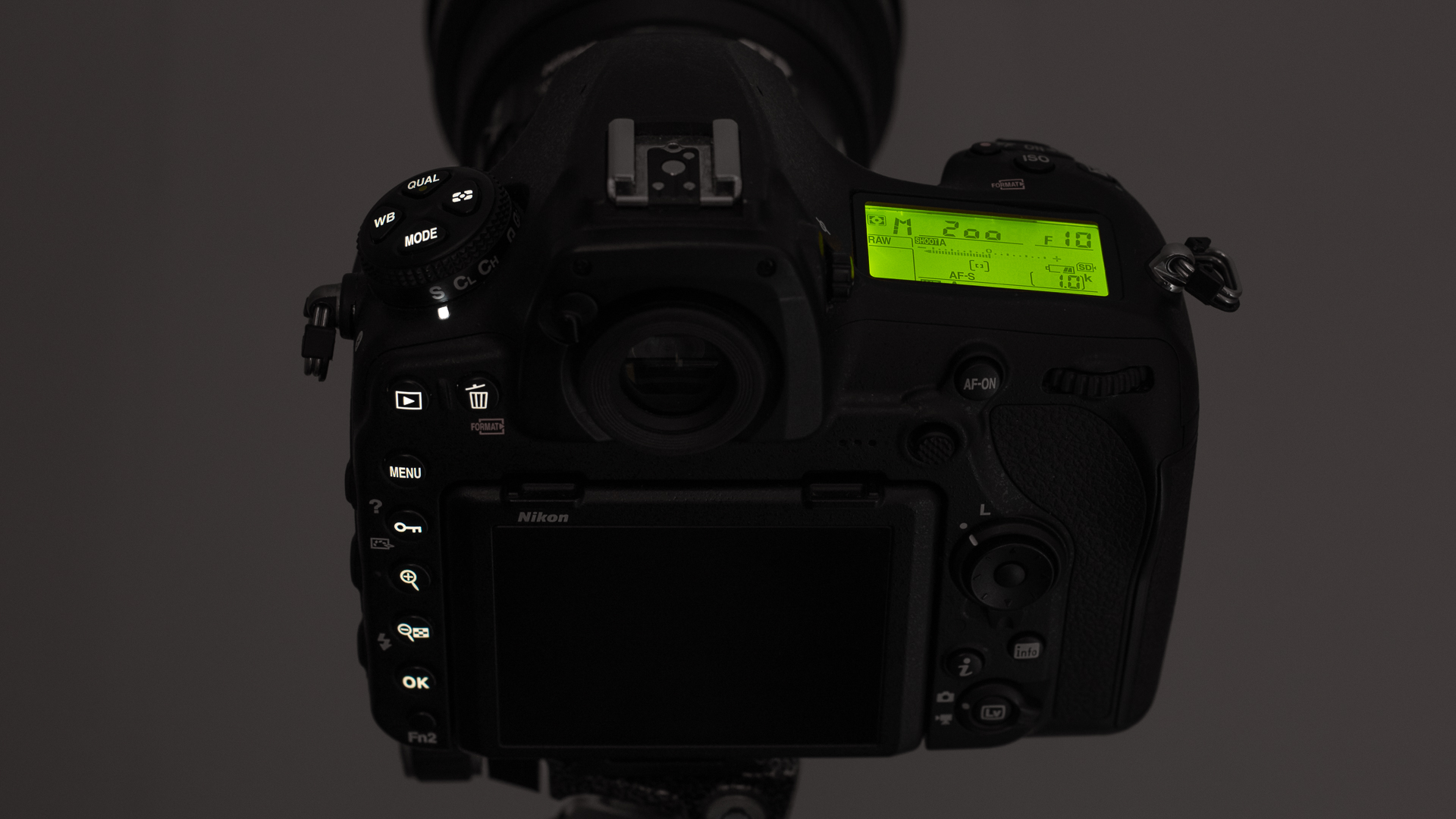 The illuminated buttons on a Nikon D850 in a dark environment