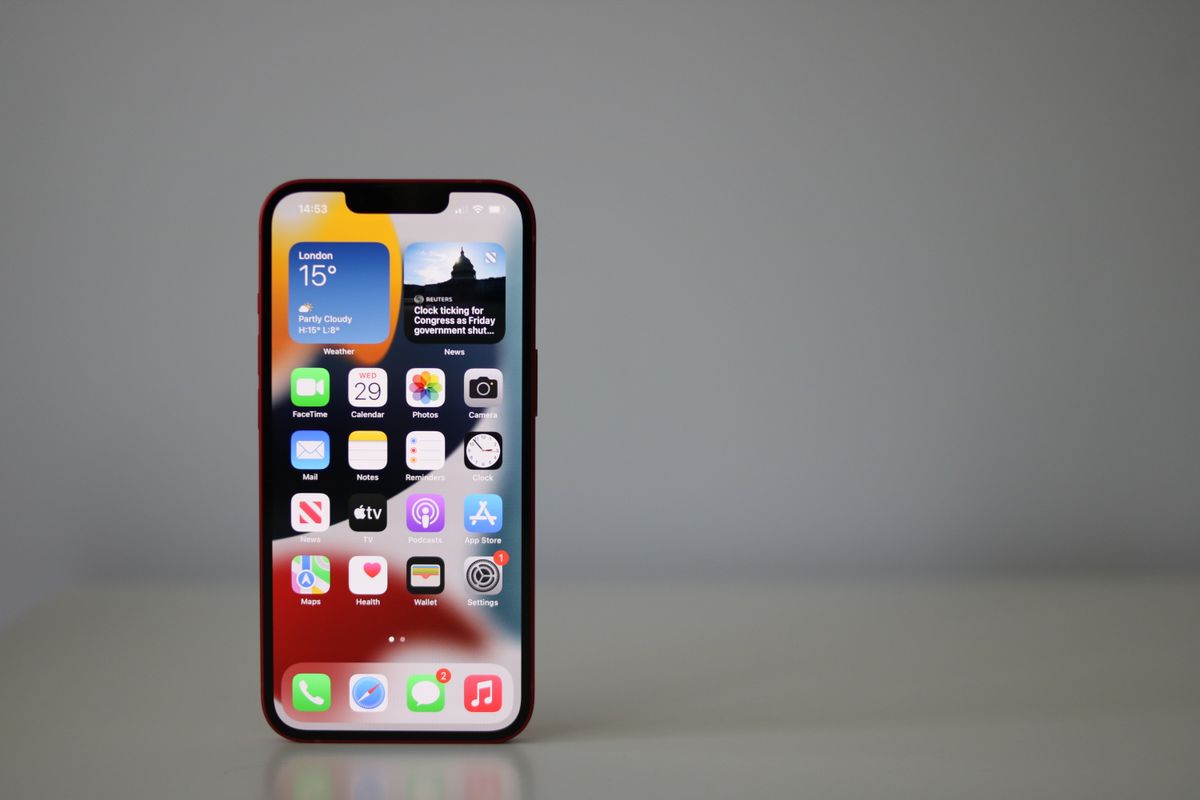 A photograph of the Apple iPhone 13 standing against a white background