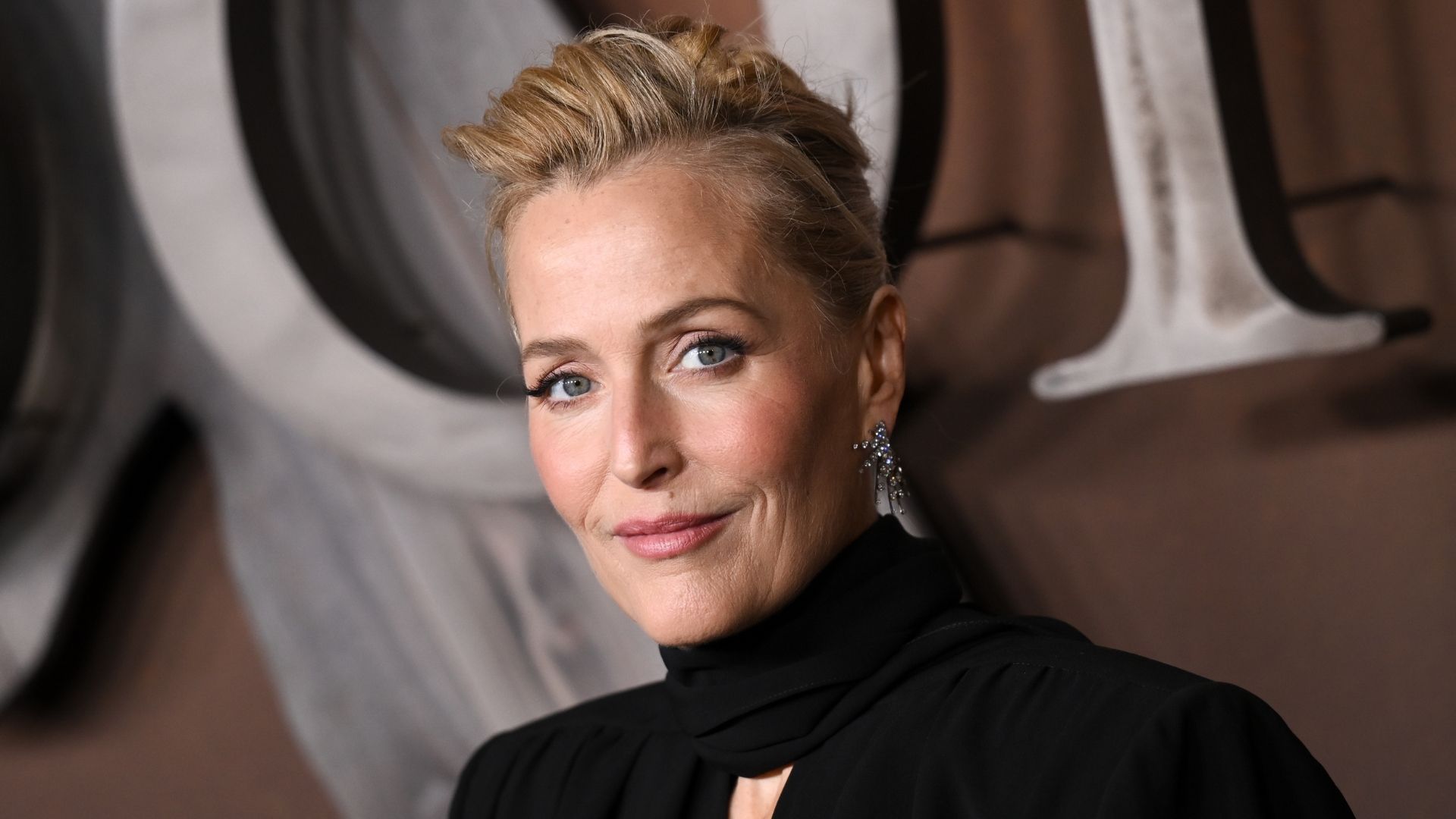 Gillian Anderson's flattering black dress is the answer to autumn occasions