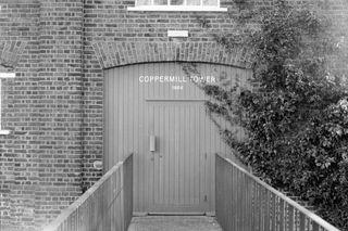 Wooden door with a name printed on it taken on Ilford HP5 Plus 35mm film