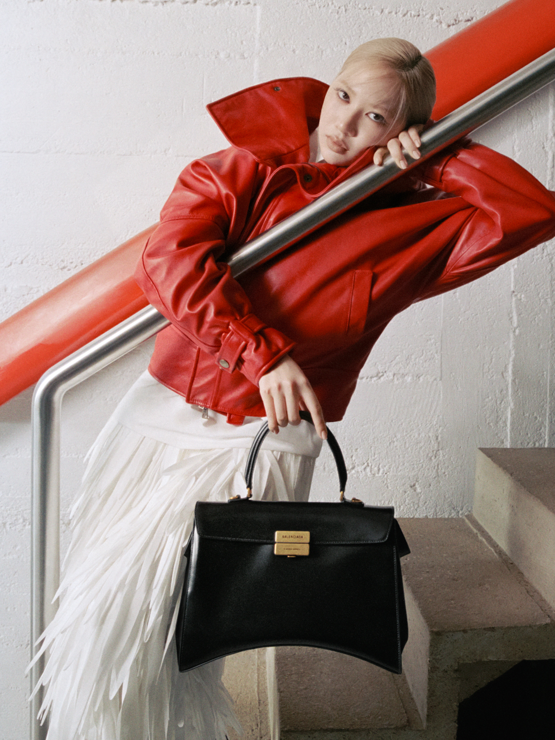 a woman carries a balenciaga avenue bag.