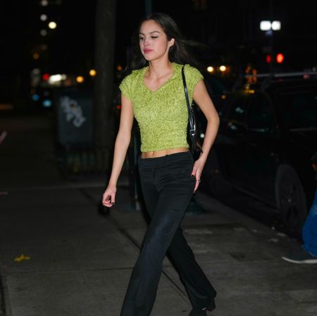 Olivia Rodrigo in a green crop top and low-waist jeans