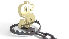 A gold dollar sign sits in the middle of a bear trap.
