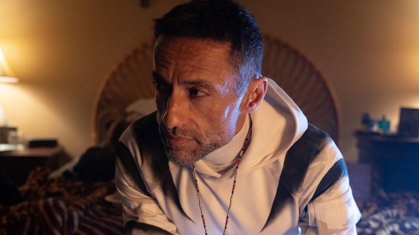 Hector Ayala sitting on a bed as he wears his White Tiger costume in Daredevil: Born Again season 1