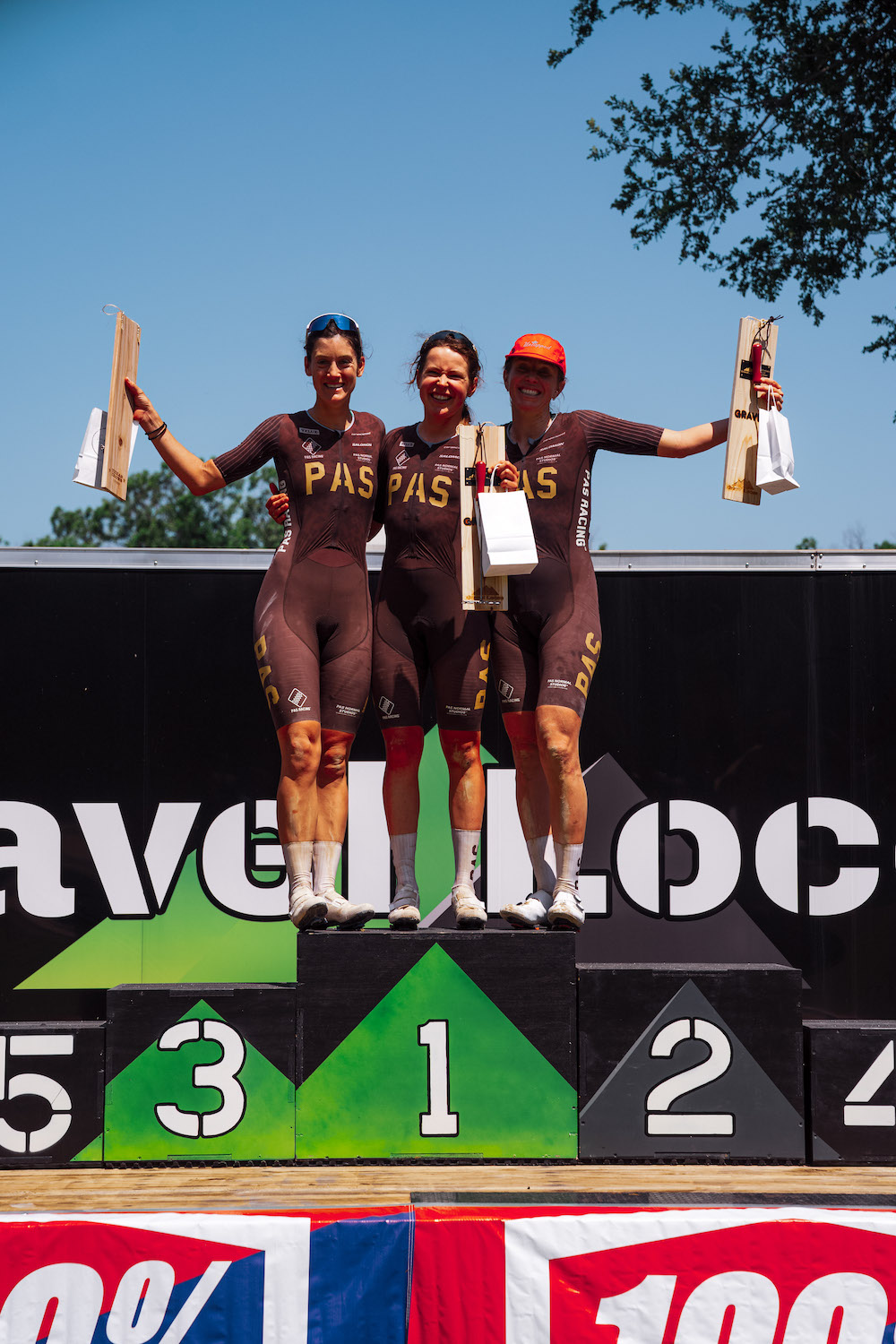 Women's podium at Gravel Locos 2025, a PAS Racing clean sweep with Karolina Migoń first, Emily Newsom second and Morgan Aguirre in third
