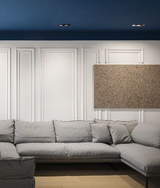 A living room with ceiling painted navy blue