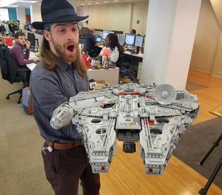 Space.com's Harrison Tasoff carries the Millennium Falcon into the video studio for it's post-build glamour shots.