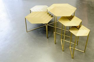 Five gold metal hectogon shaped tables