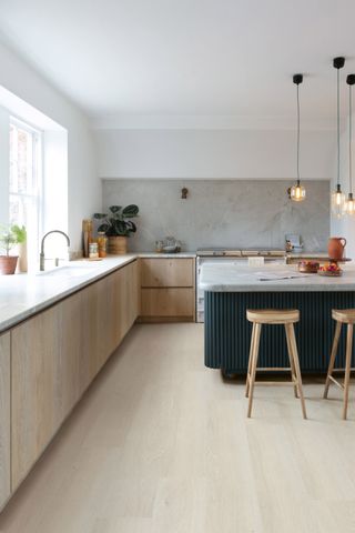 A light neutral toned modern kitchen with vinyl flooring