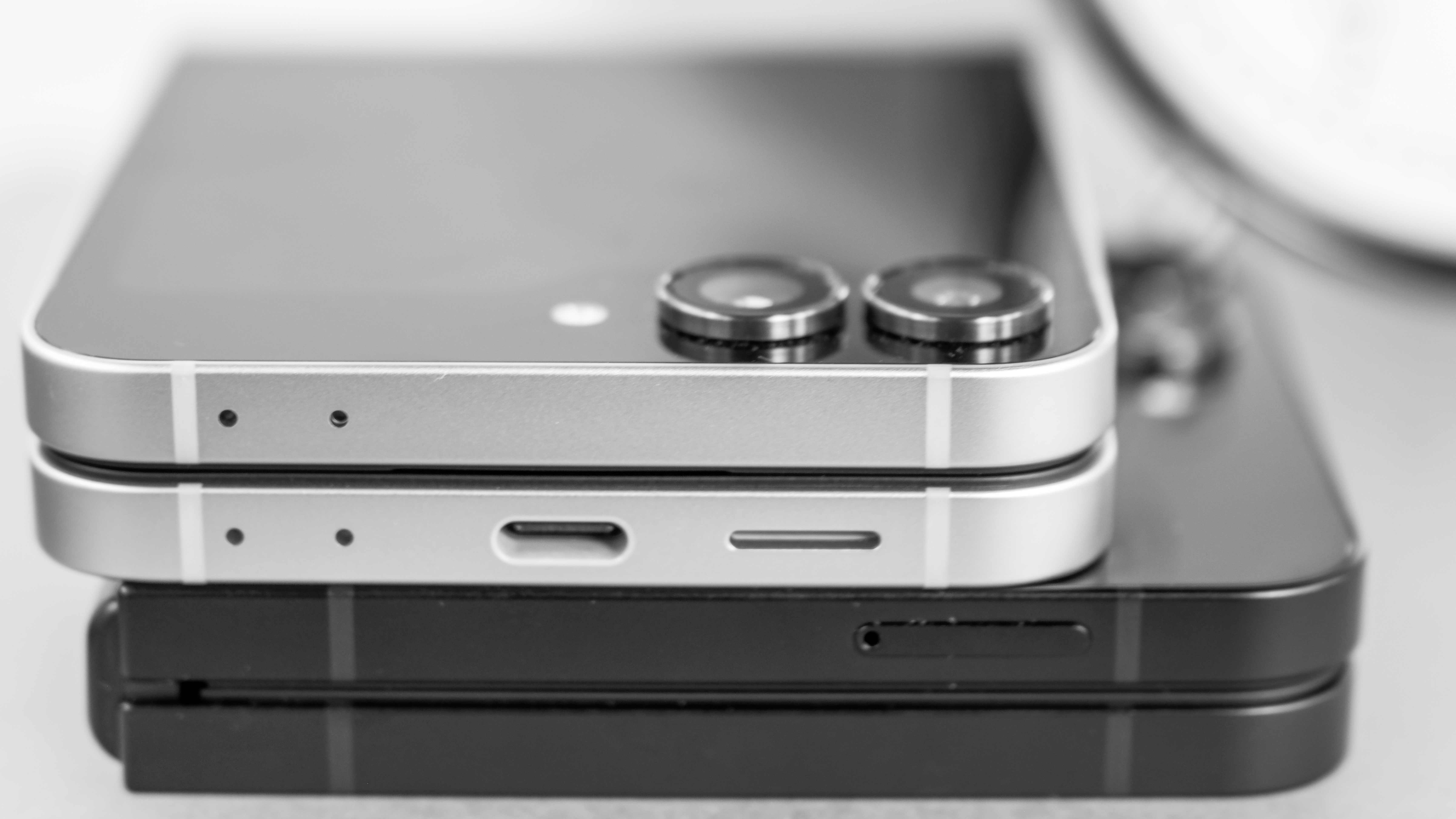 Two Samsung Galaxy Z Flip 7 FE devices stacked closed and shown from the side