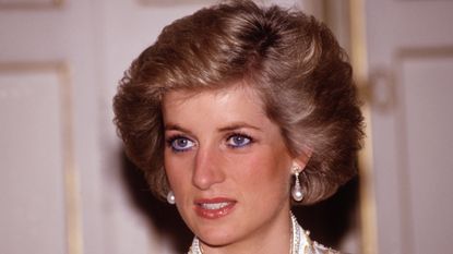 Princess Diana's secret second wedding dress explained. Seen here is Princess Diana at a dinner given by President Mitterrand in November, 1988 