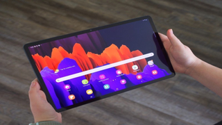 Samsung Galaxy Tab S7 Plus held in two hands in landscape orientation