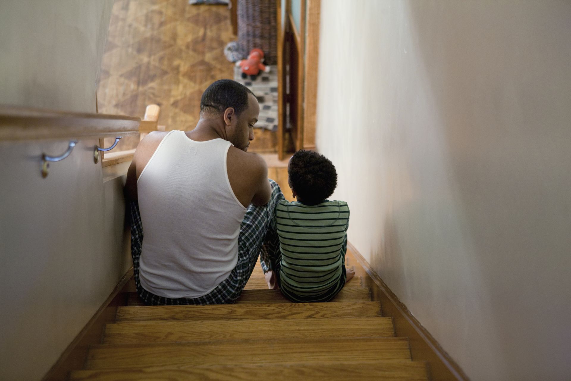 Father sitting with son on the stairs