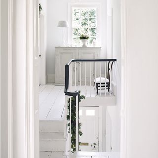 hallway with stairway and white wall